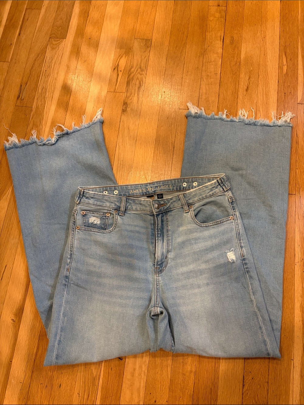 American Eagle Super High Rise Baggy Wide leg Light Wash Frayed Hem Jeans